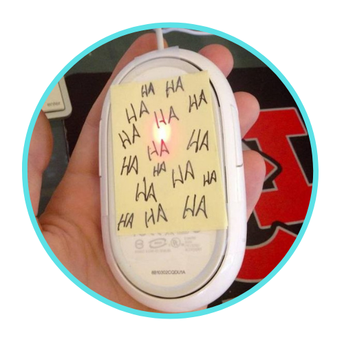 April Fool's Day Prank - Computer mouse with post it note on bottom with "ha" written multiple times
